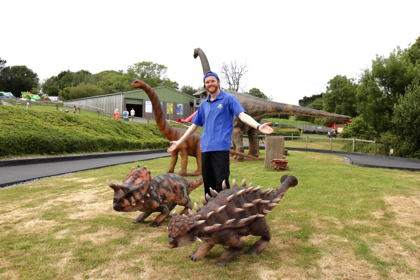 A Dinosaur Park Keeper with two small dinosaurs
